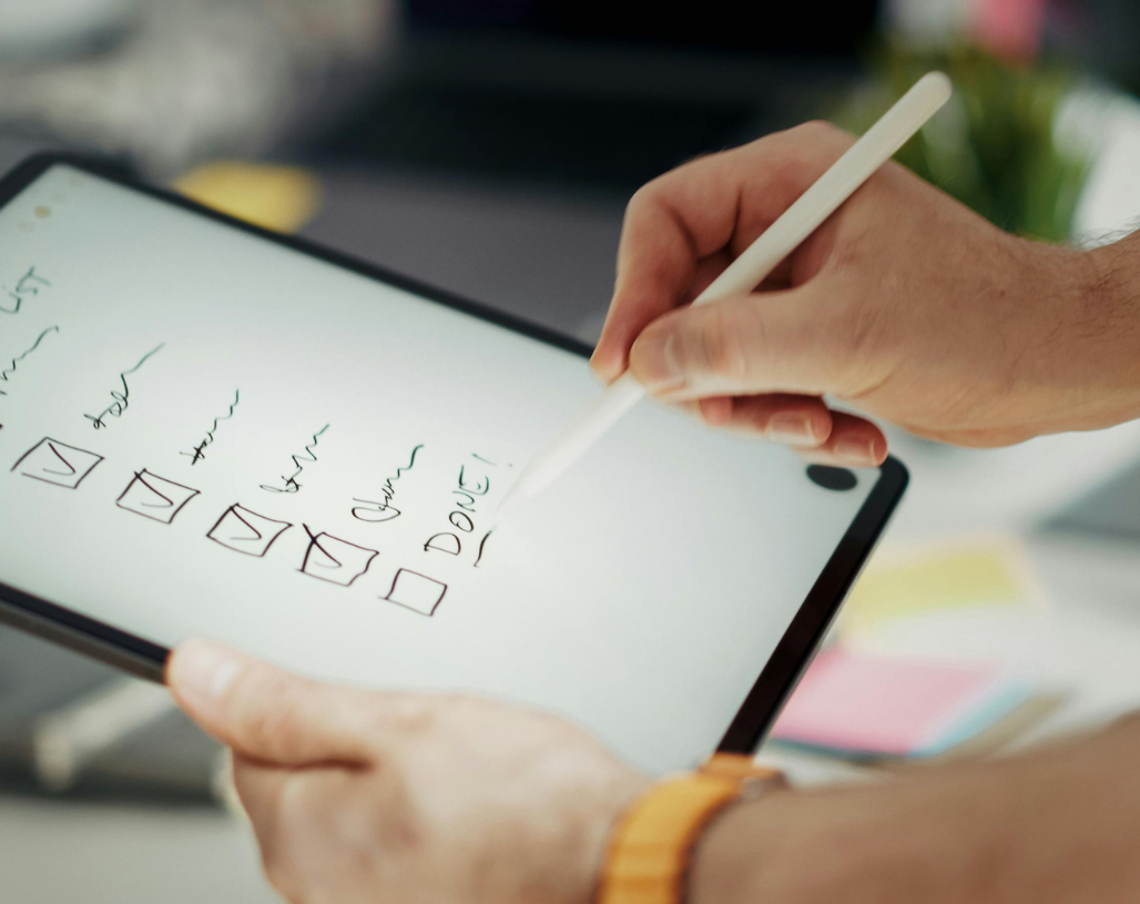 Person holding tablet with checklist